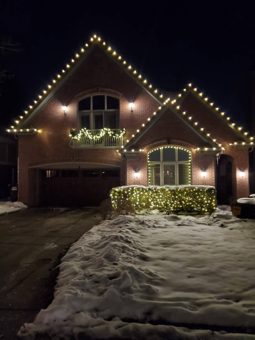 Beautifully lit home showcasing Loyal Landscaping's holiday lighting.
